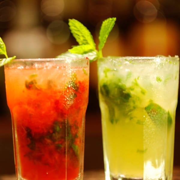 Two mojitos, one red and one green, garnished with mint leaves at Guardado's Restaurant.