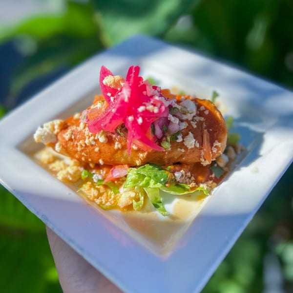 Guardado's Spanish dish with fried plantains, red pickled onions, crumbled cheese, and lettuce.